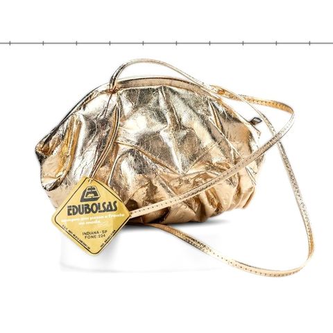 Bolsa dourada amassada com a etiqueta Edubolsas da época
